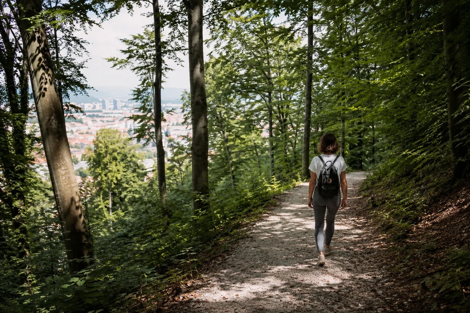 Walker on a forest trail on Roznik hill above Ljubljana