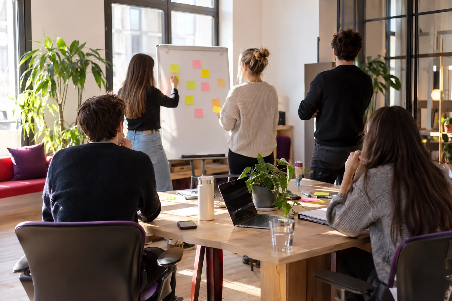 Workshop around a whiteboard with sticky notes, the working day of a team offsite in Ljubljana